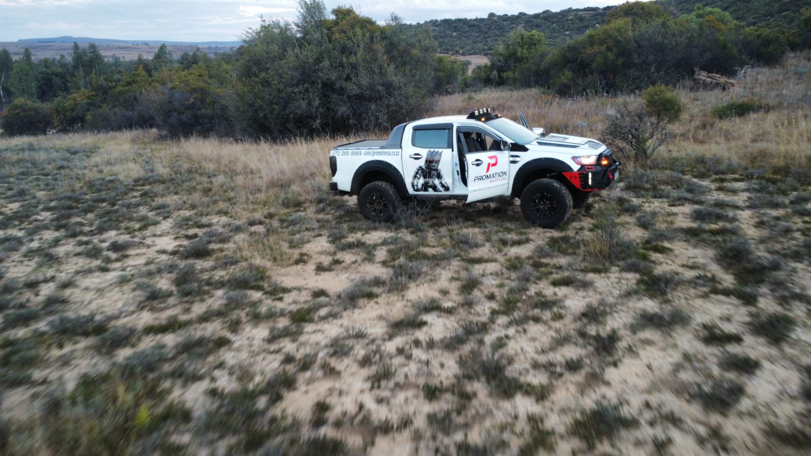 Promation SA branded service vehicle, side profile in the field